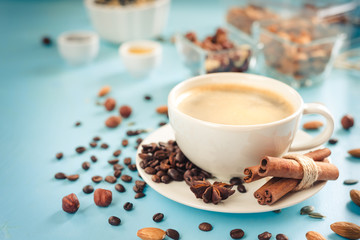 Cup of fresh coffee on blue wooden background, top view