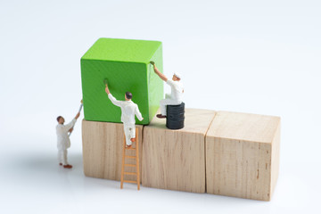 miniature people worker painting wood cube building block
