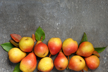 Juicy pears on the gray background with a free space