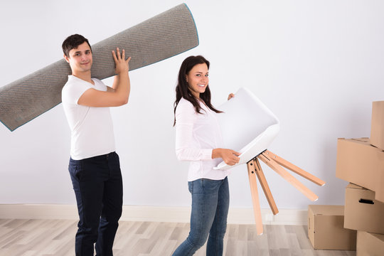 Couple Carrying Furniture