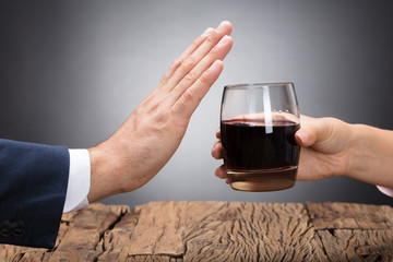 Businessperson Rejecting Glass Of Whiskey