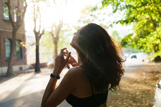 Sensual girl in sunlight at street