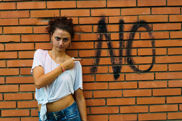 Woman pointing at word on wall