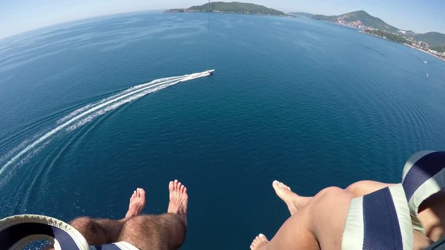 Couple enjoying parasailing