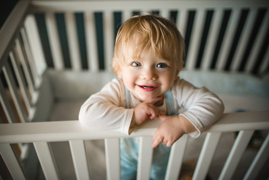 Portrait of baby girl in cot