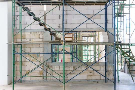 Modern Scaffolding With Concrete Wall At A Construction Site