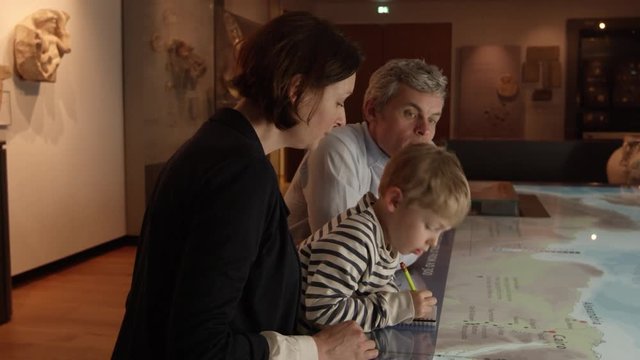 Family On Trip To Museum Looking At Map Shot On R3D