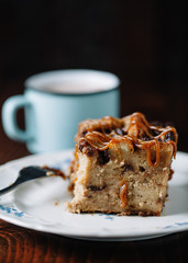 Bread pudding with caramel sauce served with a cup of hot cocoa