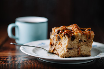 Bread pudding with caramel sauce served with a cup of hot cocoa