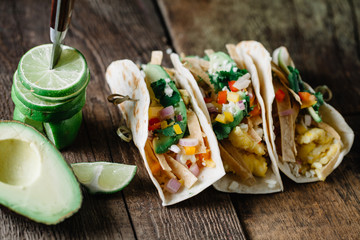 Breakfast tacos with eggs, avocado and fresh cut vegetables