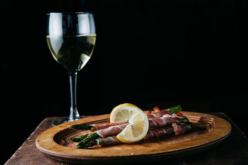 Bacon Wrapped Grilled Asparagus on a wooden plate