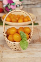 Fresh yellow tomatoes organic on wood background