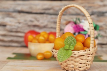 Fresh yellow tomatoes organic on wood background
