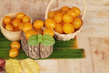 Fresh yellow tomatoes organic on wood background