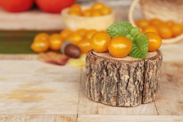 Fresh yellow tomatoes organic on wood background