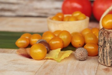 Fresh yellow tomatoes organic on wood background