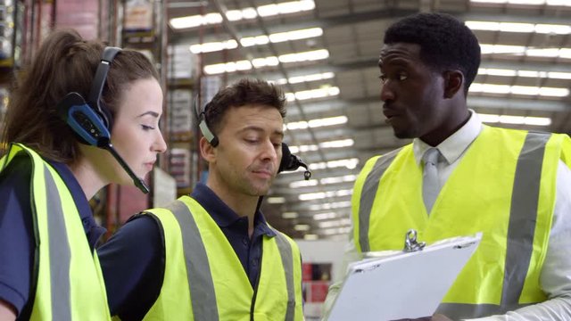 Manager giving instructions to warehouse staff, shot on R3D