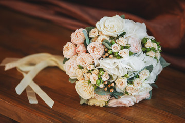 Wedding bouquet of roses on wooden background. Marriage concept