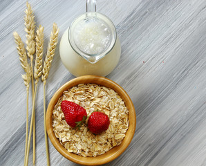 Overhead view of Oats with milk and strawberries