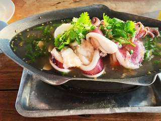 steam squid with spicy chilli and lemon sauce in seafood restaurant