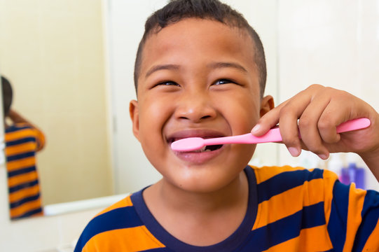 Asian boy brushing teeth in bathroom with tooth brush healthy lifestyle,child dental care.