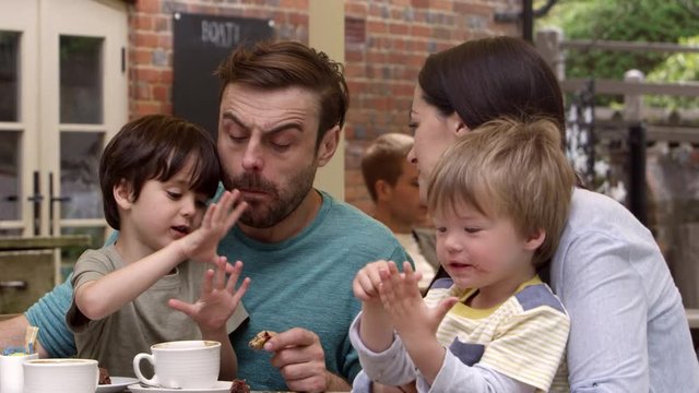 Family Sit At Outdoor Cafe Table Having Snack Shot On R3D