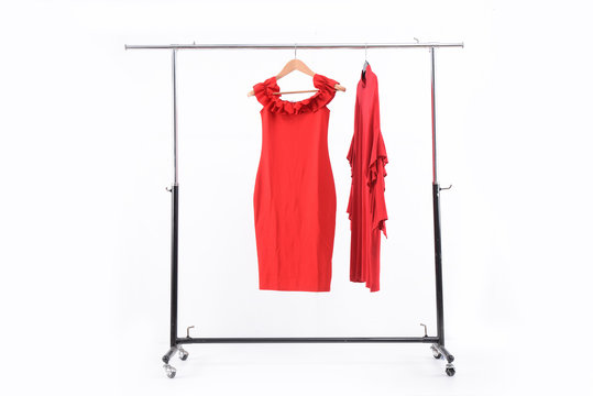 Female Two Red Dress On Hanger On Wooden Background 

