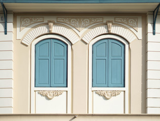 Blue painted wood arched windows in classic wall
