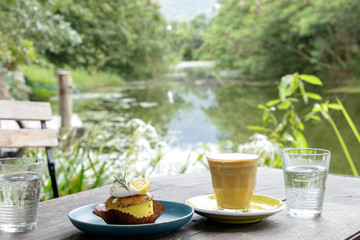 Breakfast set in garden, Snack for Afternoon tea set with scenery, Coffee with lemon poppy seed cake.