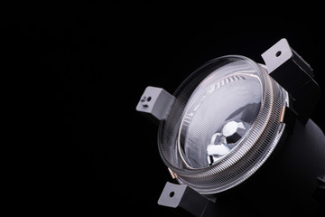 Naklejka premium close-up round car headlights on a black background isolated