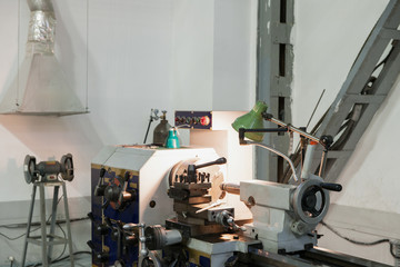 turning lathe in the workshop illuminated by the lamp