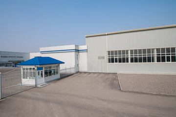 general view of the factory with a checkpoint and fence