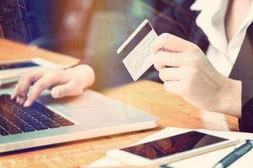 female hand of business woman holding credit card making purchase online