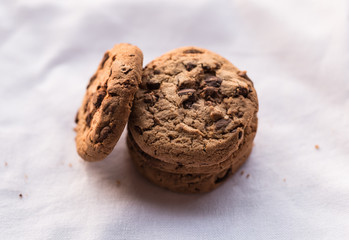 Stack of chocolate chips cookies on white background