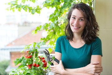 Portrait of a woman on her city garden balcony - Nature and city theme