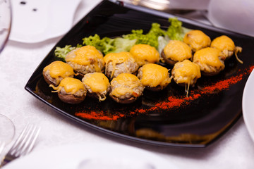 stuffed mushrooms in a black plate