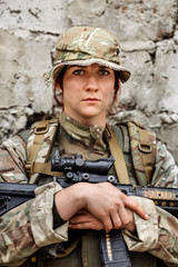 Portrait woman soldier or private military contractor holding sniper rifle.