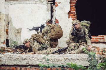 Army soldier during the military operation in the city. war, army, technology and people concept.
