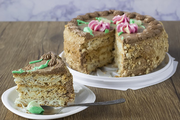 Nut cake with cream  flowers and leafs and chocolate cream  as decoration