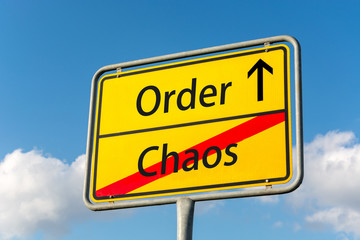 Yellow street sign with Order ahead leaving Chaos behind