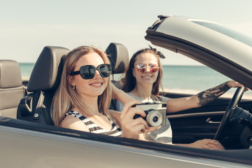 Happy friends in car