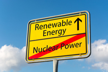 Obraz premium Yellow street sign with renewable energy ahead leaving nuclear power behind