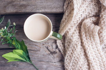 Cup of coffee and scarf on the wood. Autumn