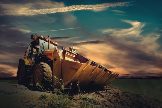 Fototapeta Yellow tractor on sky background
