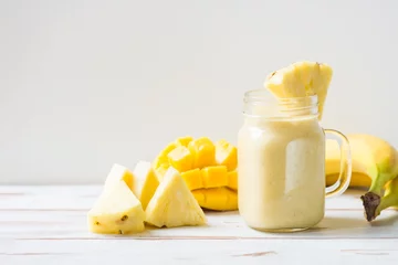Foto auf Acrylglas Milchshake Mango, Banana, Pineapple and Oatmeal Smoothie in the Jar