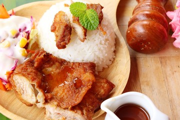 Fried chicken rice with sauces and vegetable salad