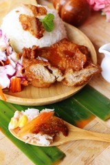 Fried chicken rice with sauces and vegetable salad