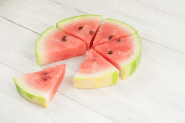 Lot of slices of fresh ripe watermelon and one slice separately on old wooden rustic