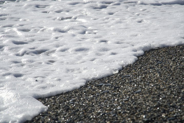 Wave white foam on the beach                                                   