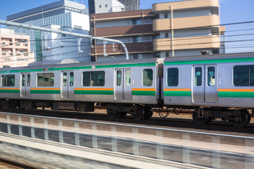 Fototapeta na wymiar Train in motion on the railway of Tokyo, Japan